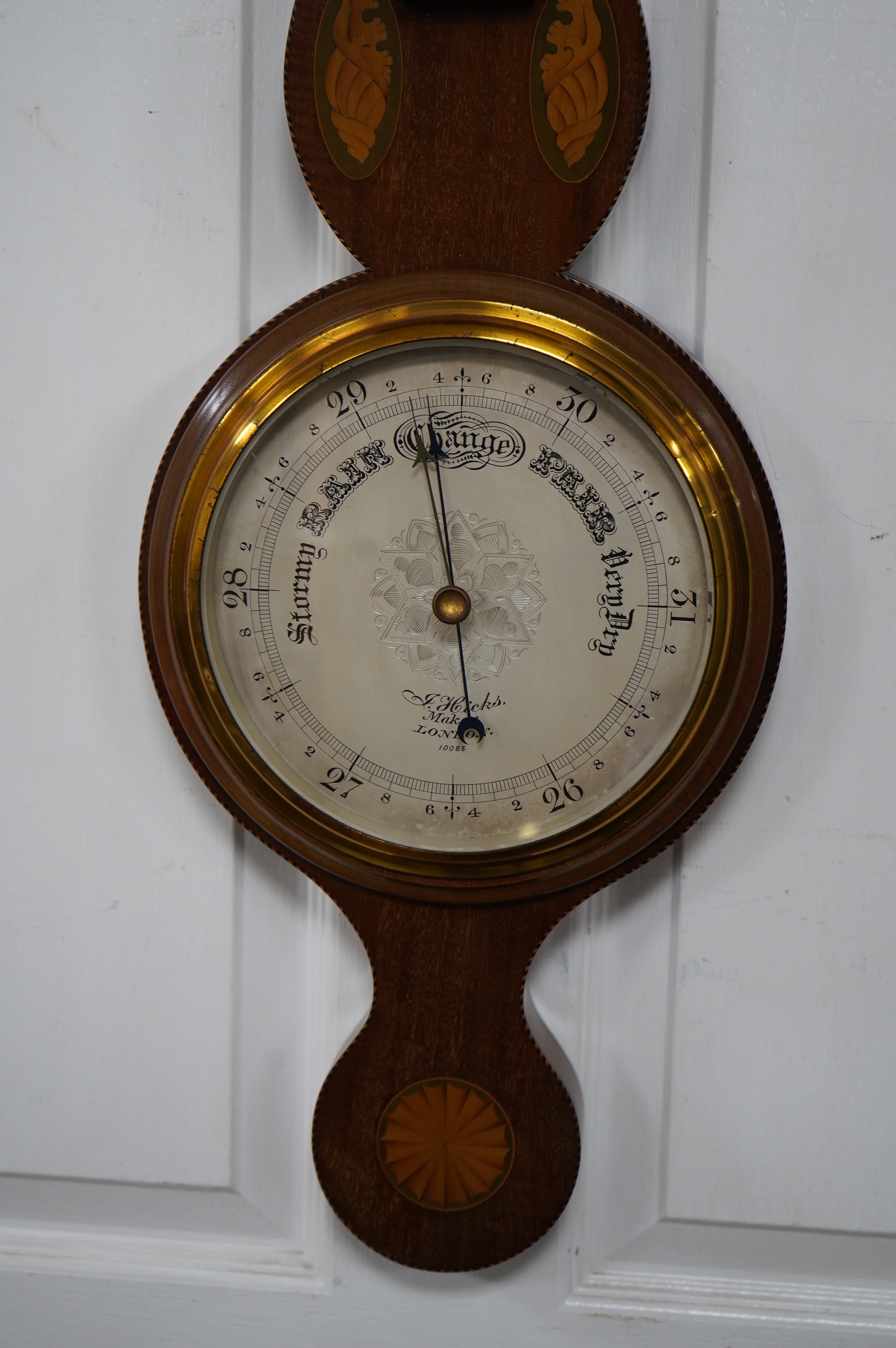 An Edwardian mahogany shell inlaid banjo barometer, maker J Hicks - London, 96cm high. Condition - good